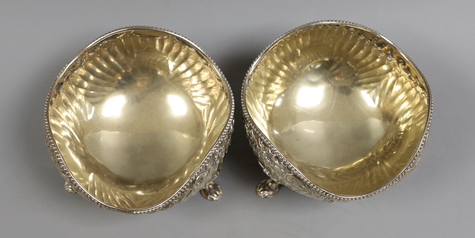 A pair of late Victorian fluted silver sweetmeat bowls, on tripod supports, Daniel & John Welby, London, 1885, diameter 10.7cm, 12.1oz.